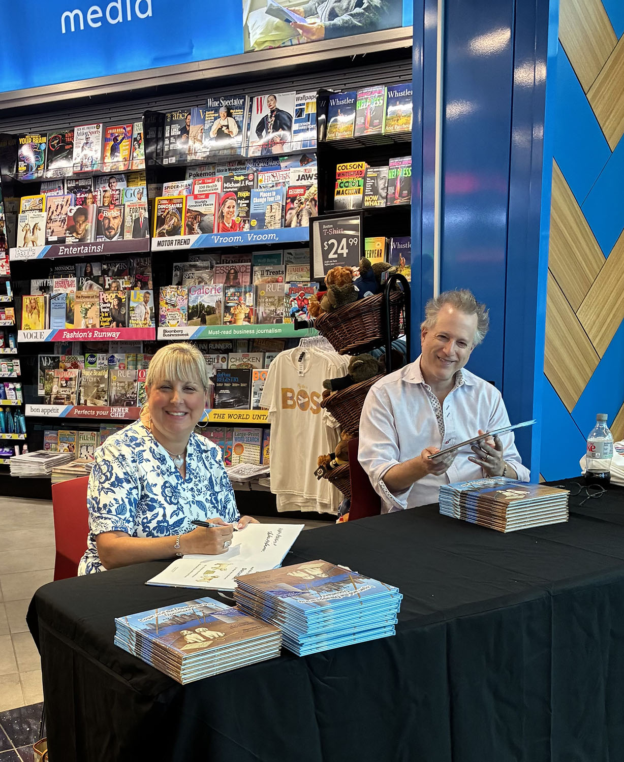Christine Ricci-McNamee signing at her table at Logan Airport